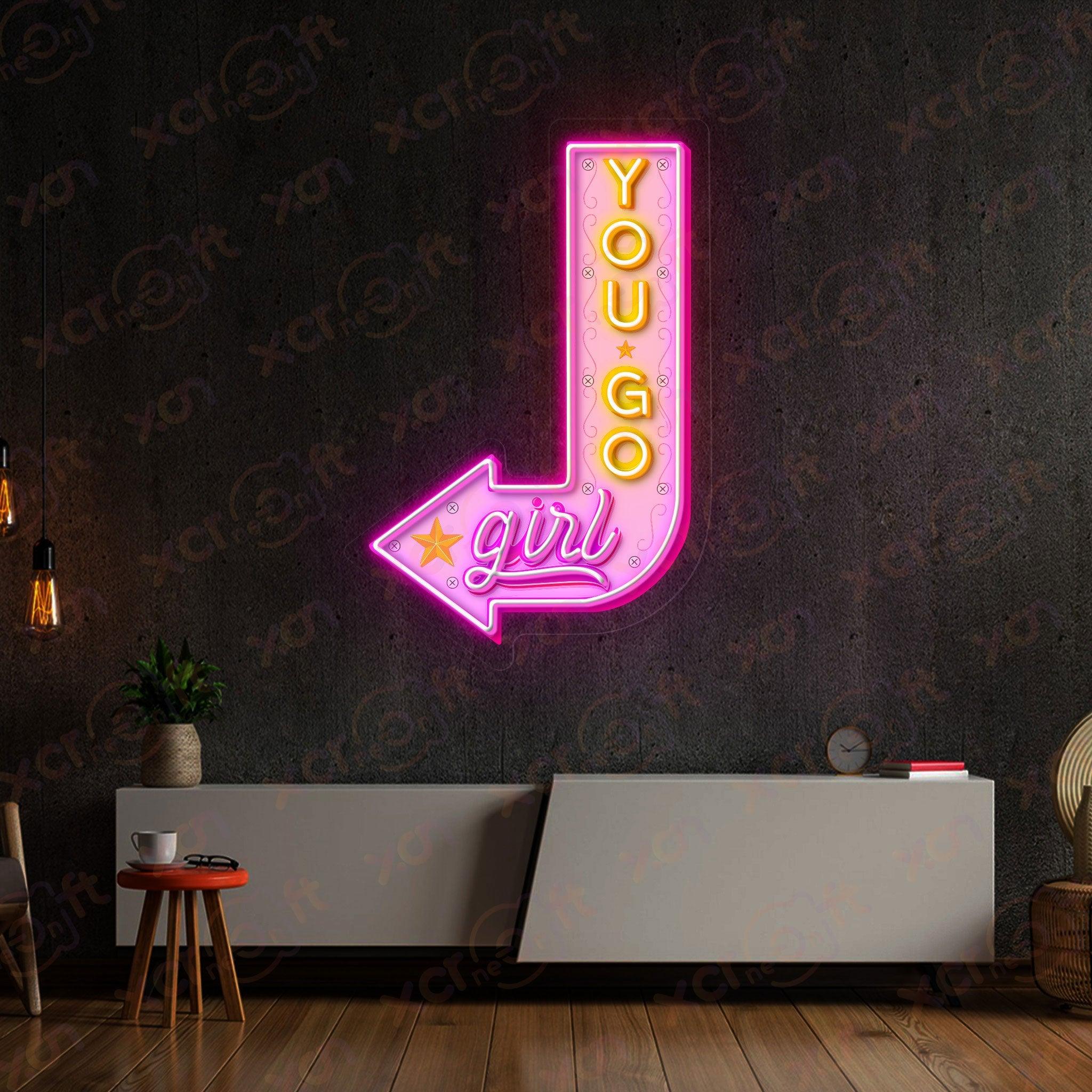 Arrow-shaped neon sign with positive message for girls.