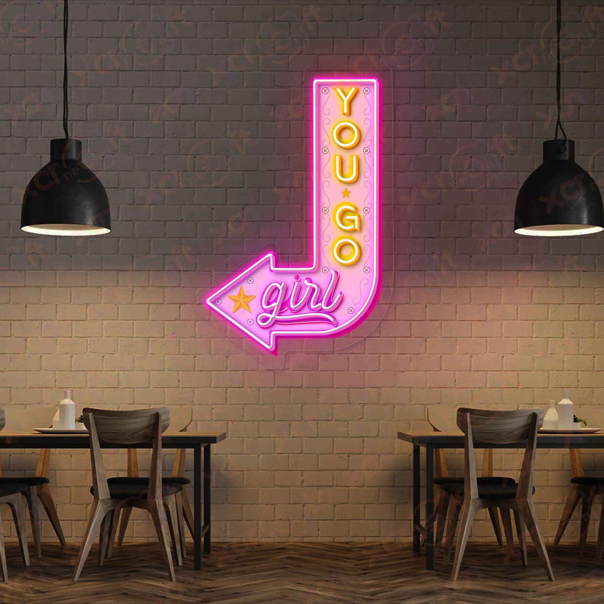 Pink neon sign encourages girls with "You Go Girl".